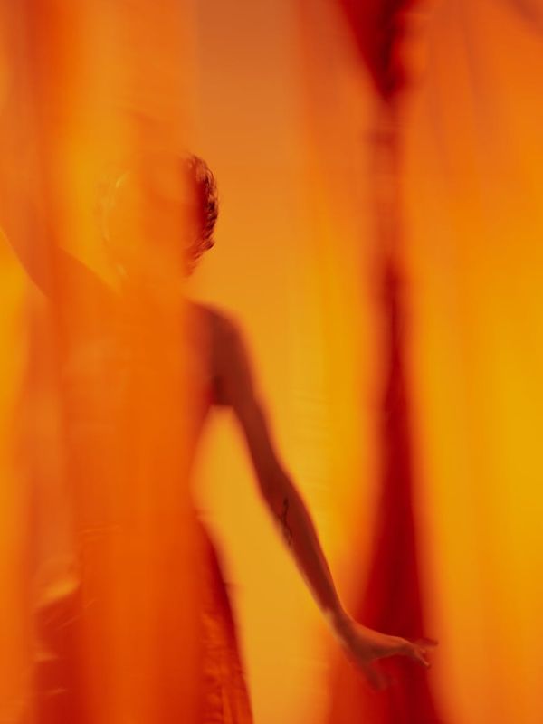 Abstract silhouette of a woman's body with flowing energy lines.